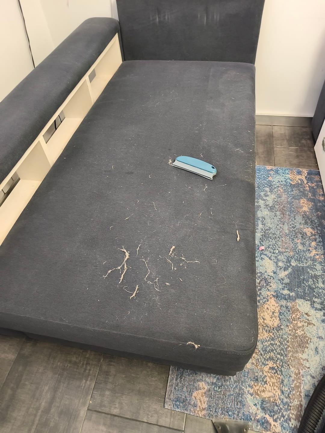 sofa with film before cleaning, adhesive marks on the seat