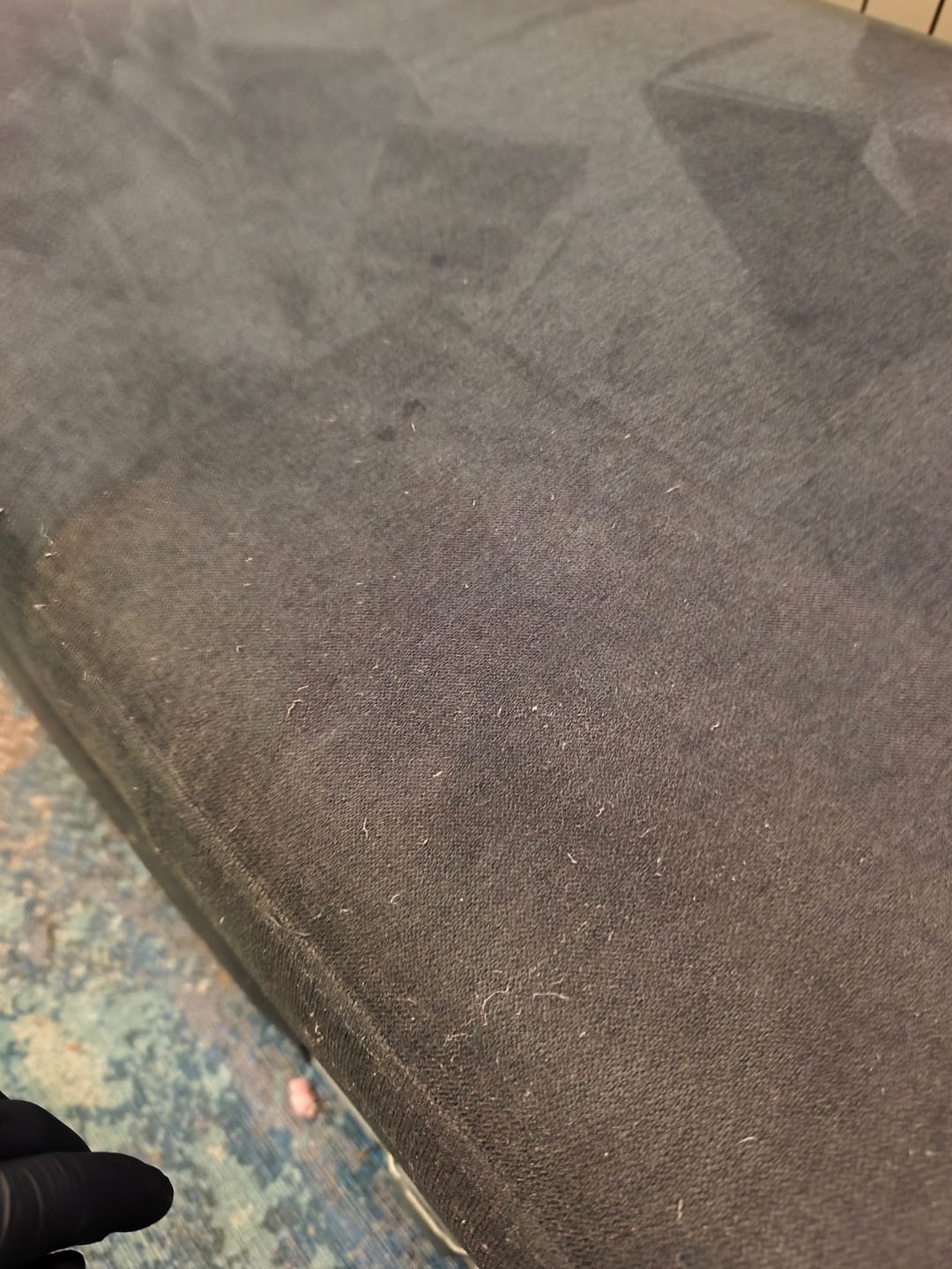 close-up of adhesive marks from protective film on sofa fabric